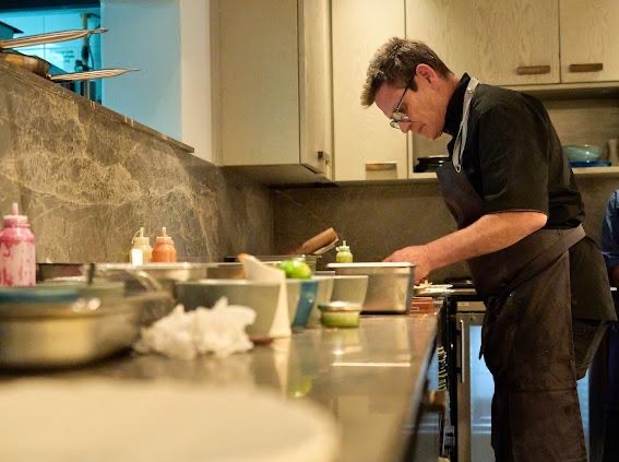 Gerard Van Staden preparing dishes in the kitchen
